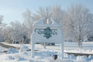 Quit Qui Oc Golf course sign in winter covered with snow